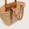 24,7-väska i naturlig raffia och brunt läder med detaljer i guldmetall