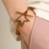Armband i antikguldfärgad kedja med avtagande länkar och stjärnformat lås