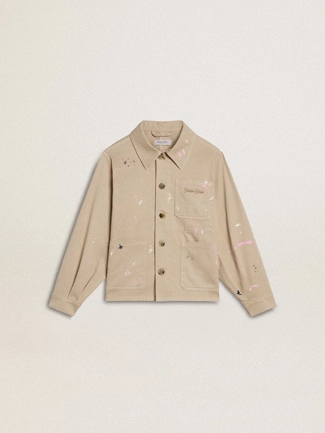Beige barnjacka med flerfärgade stänk