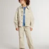 Beige barnjacka med flerfärgade stänk