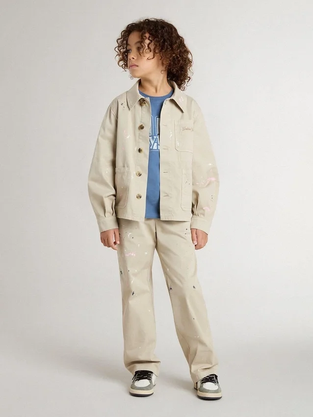 Beige barnjacka med flerfärgade stänk