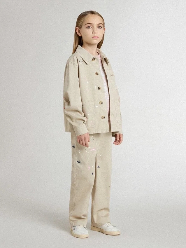 Beige barnjacka med flerfärgade stänk