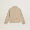 Beige barnjacka med flerfärgade stänk