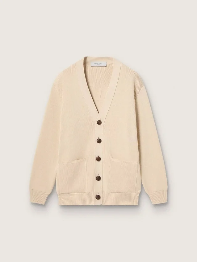 Beige damkofta med texten ”Golden” på ryggen