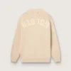 Beige damkofta med texten ”Golden” på ryggen