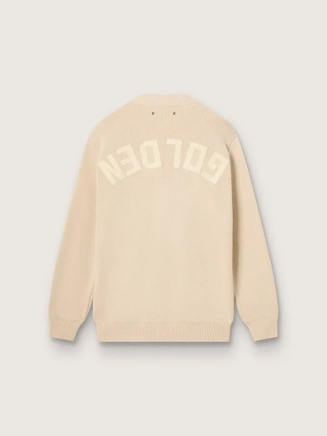 Beige damkofta med texten ”Golden” på ryggen