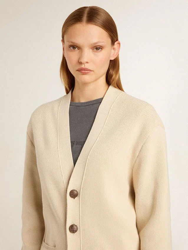 Beige damkofta med texten ”Golden” på ryggen
