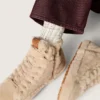 Krämfärgade strumpor med slitna detaljer och strass