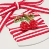 Skinn röda och vita skosnören med körsbärsberlock