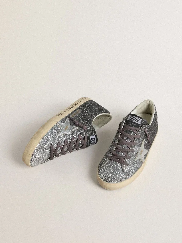 Super-Star för dam med glitteröverdel och silvermetallisk läderstjärna