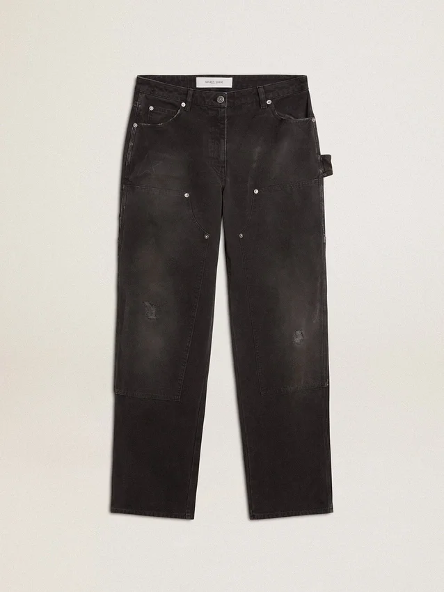 Svarta jeans i bomull med slitna detaljer och lappar framtill för dam