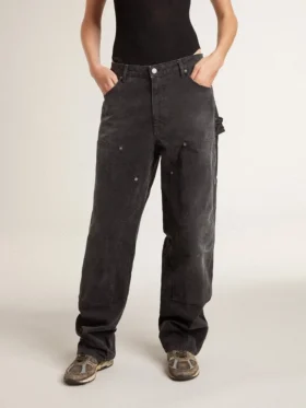 Svarta jeans i bomull med slitna detaljer och lappar framtill för dam