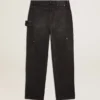 Svarta jeans i bomull med slitna detaljer och lappar framtill för dam