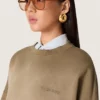 Unisex-sweatshirt i militärgrön bomull med blekt utseende och broderad logotyp
