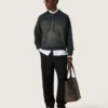 Unisex-sweatshirt med huva i svart bomull med blekt effekt