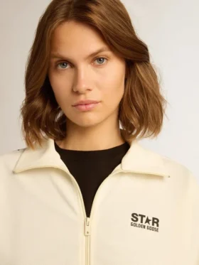 Vit damsweatshirt med dragkedja, vit rand och svarta stjärnor