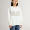 Vit sweatshirt för flickor med mångfärgad guldfärgad text på framsidan