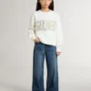 Vit sweatshirt för flickor med mångfärgad guldfärgad text på framsidan