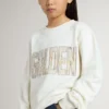Vit sweatshirt för flickor med mångfärgad guldfärgad text på framsidan